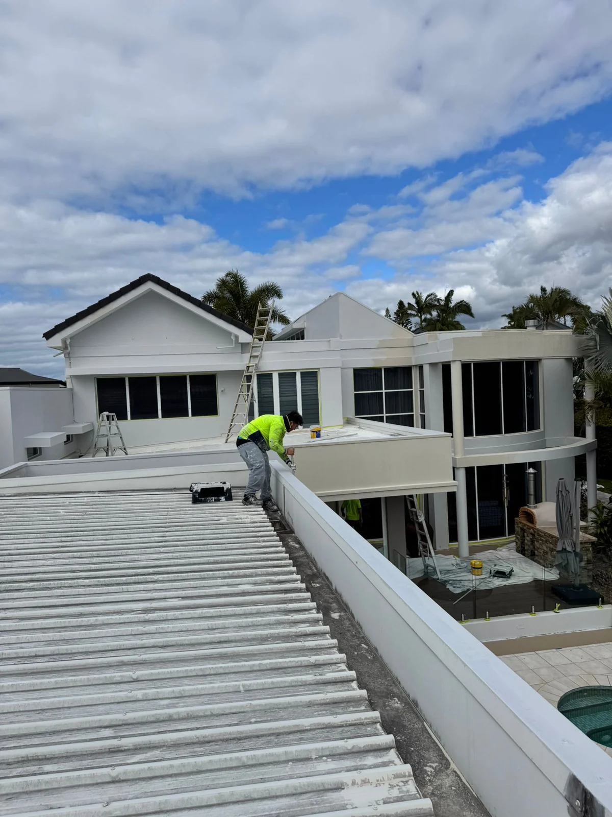Painter at work on a residential roofline